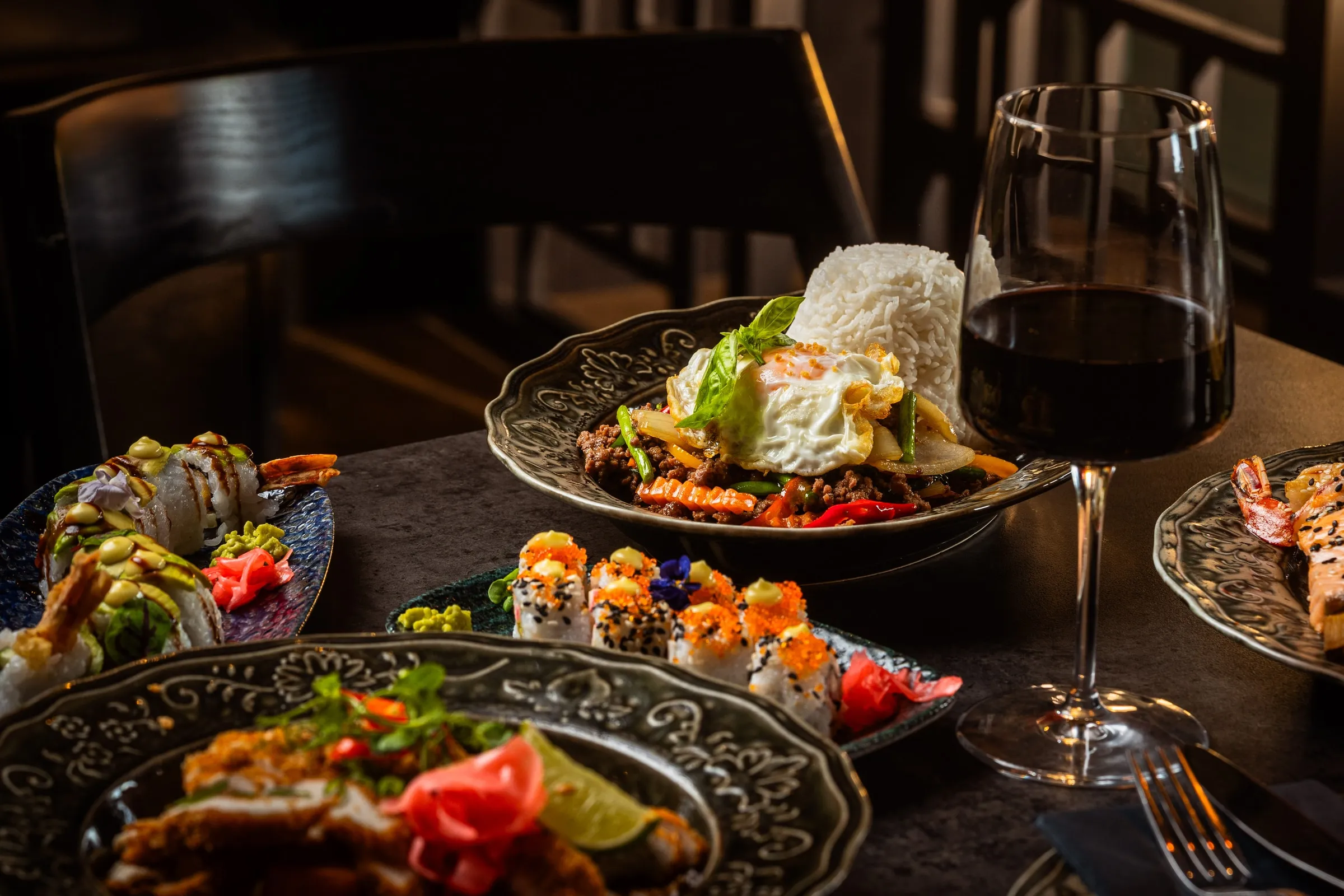 Sushi, curry, rice and vegetables served together with red wine at Lotus Lounge.